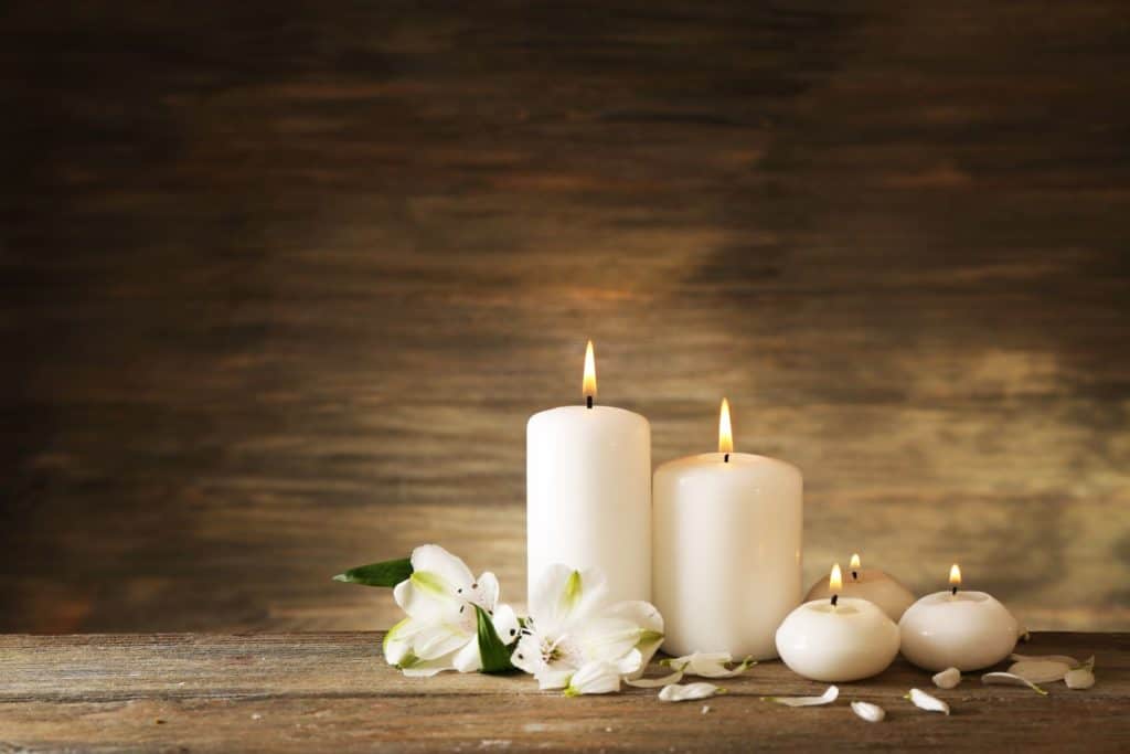 candles and flowers on a wooden table